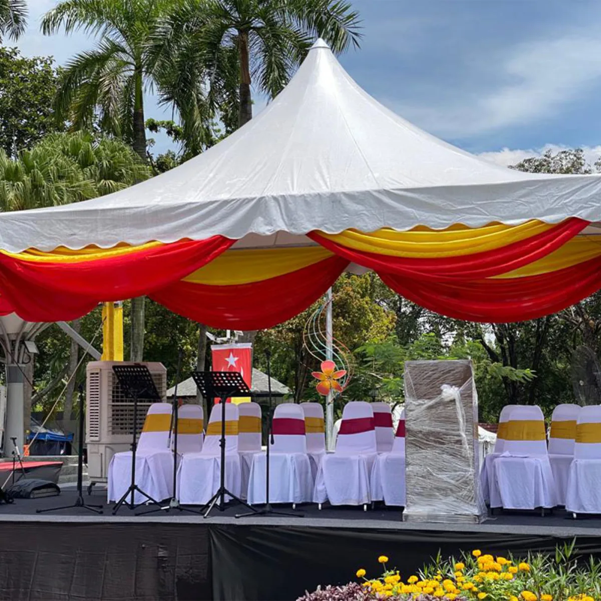 White peaked canopy arranged for seated guests