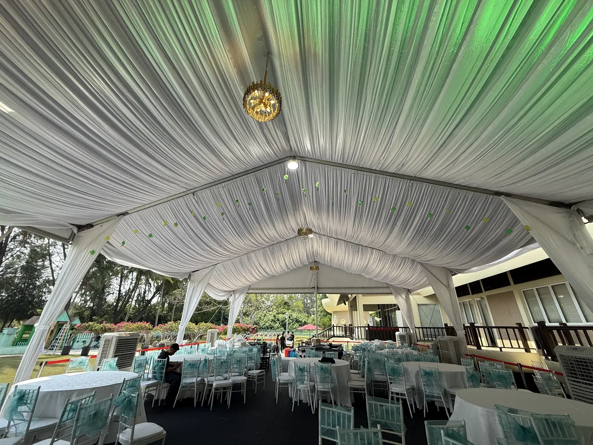Draped marquee interior with a chandelier and green uplighting