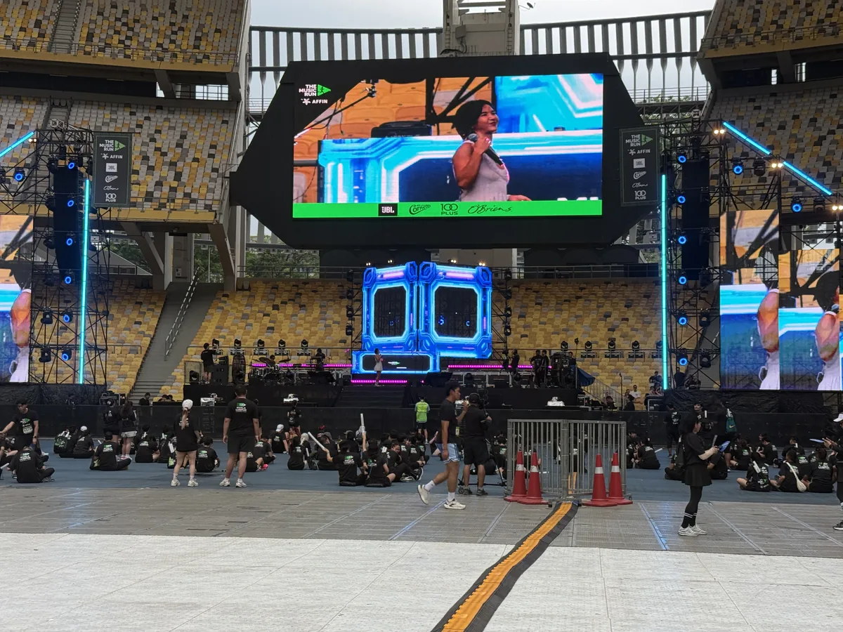 Stadium stage with a large LED screen and LED towers