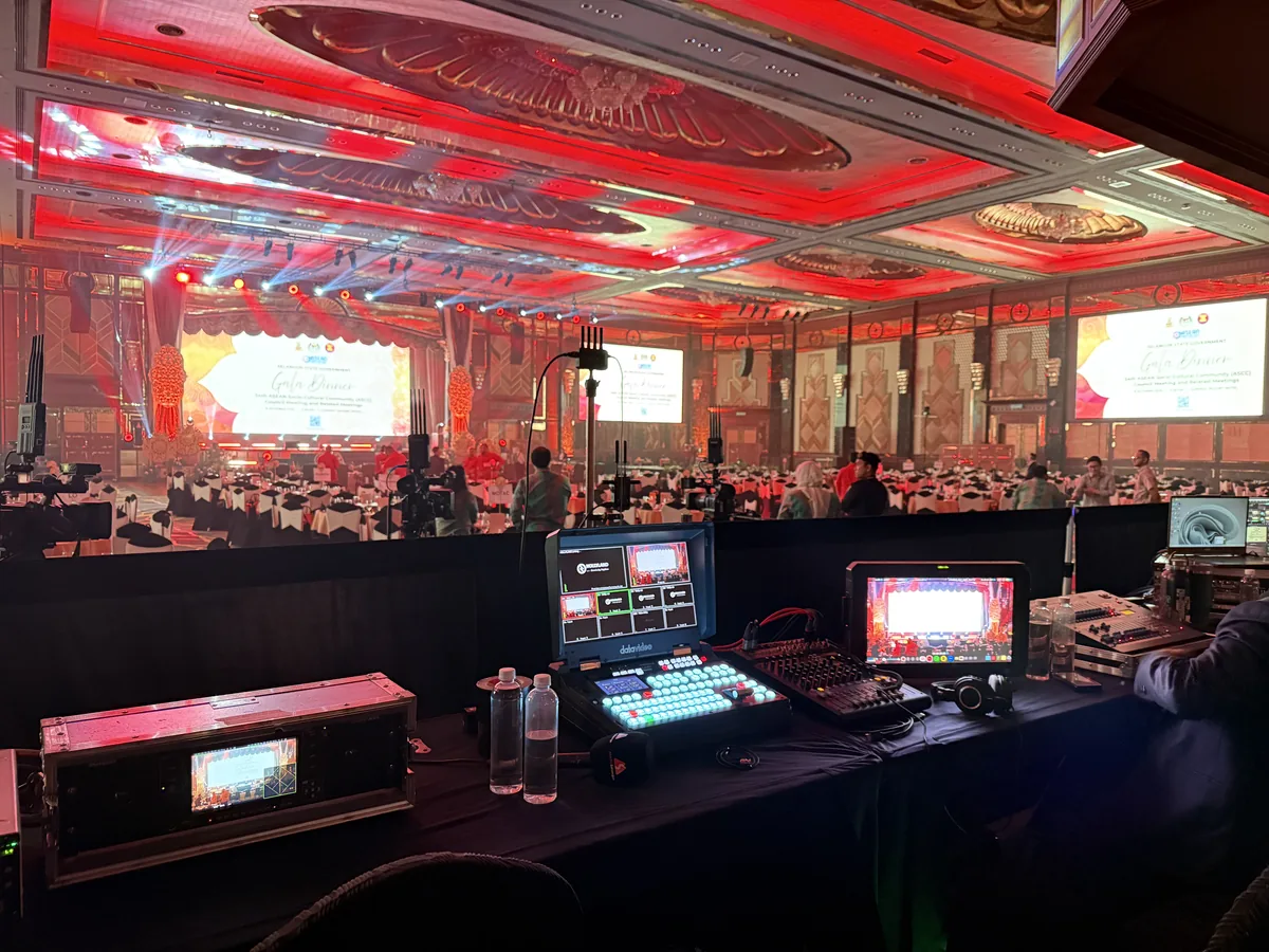 Control desk with switcher and monitors facing a gala stage
