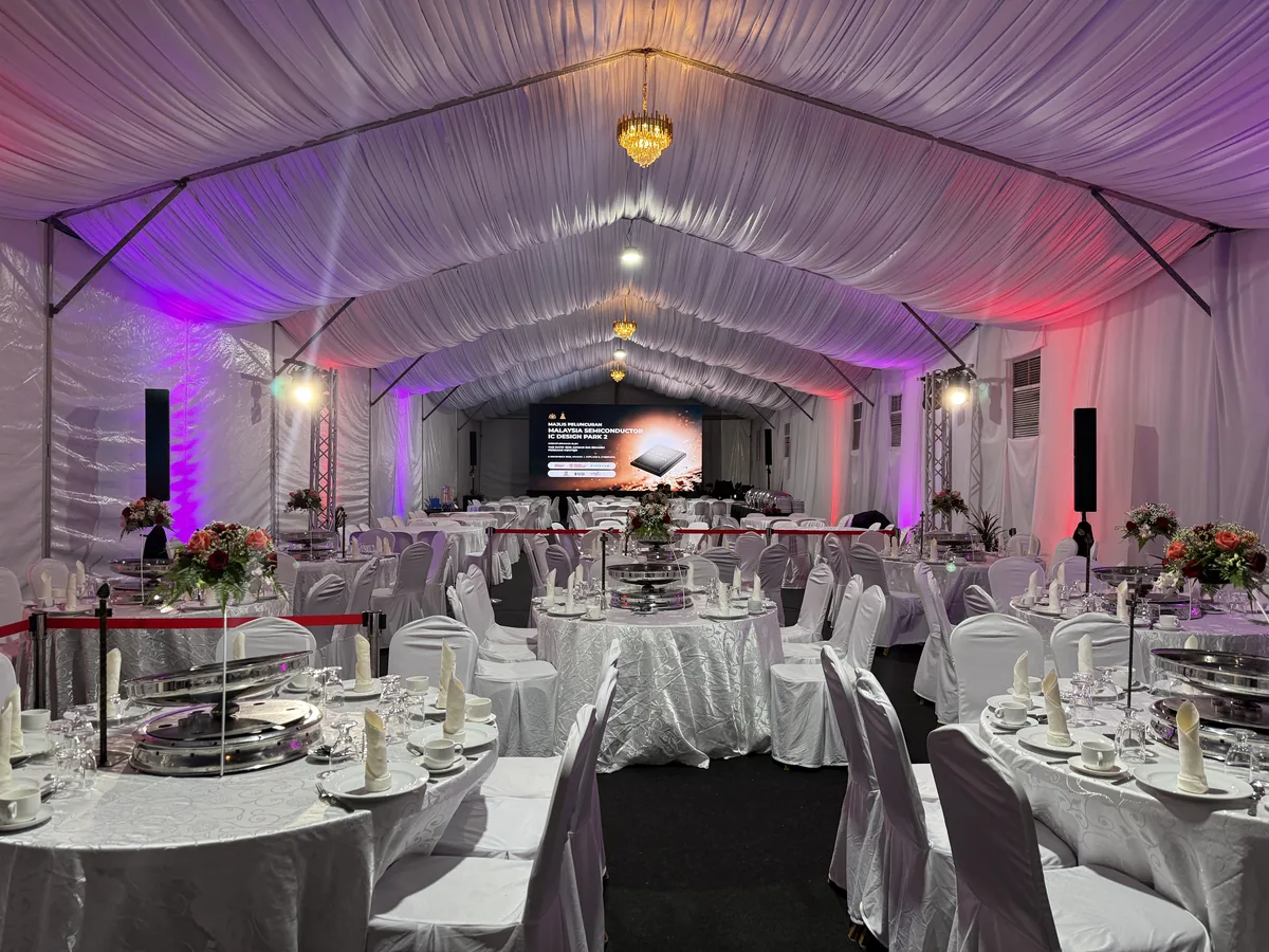 Marquee dining hall with purple uplighting and set tables